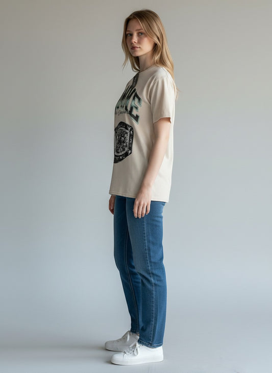 Homme + Femme LA tan 100% cotton crew neck t-shirt with graphic print, worn by a woman.