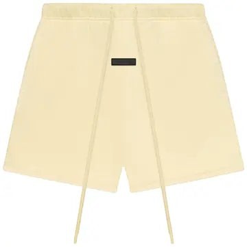 Verified Vault Fear of God Essentials sweatshort in golden yellow, featuring a relaxed fit, elastic waistband, and elongated drawcord.